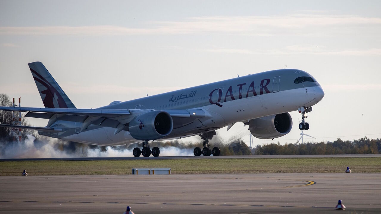 1229451023 An Airbus A350 plane of Qatar Airways from Doha is pictures after it landed at Berlin's airport "Berlin Brandenburg Airport Willy Brandt", during the opening of the southern runway of the airport, in Schoenefeld, southeast of Berlin, on November 4, 2020. - Passenger flights are to began landing on October 31, 2020 at Berlin's new international airport, a moment many Germans thought they might never see after years of embarrassing delays and spiralling costs. (Photo by Odd ANDERSEN / AFP) (Photo by ODD ANDER