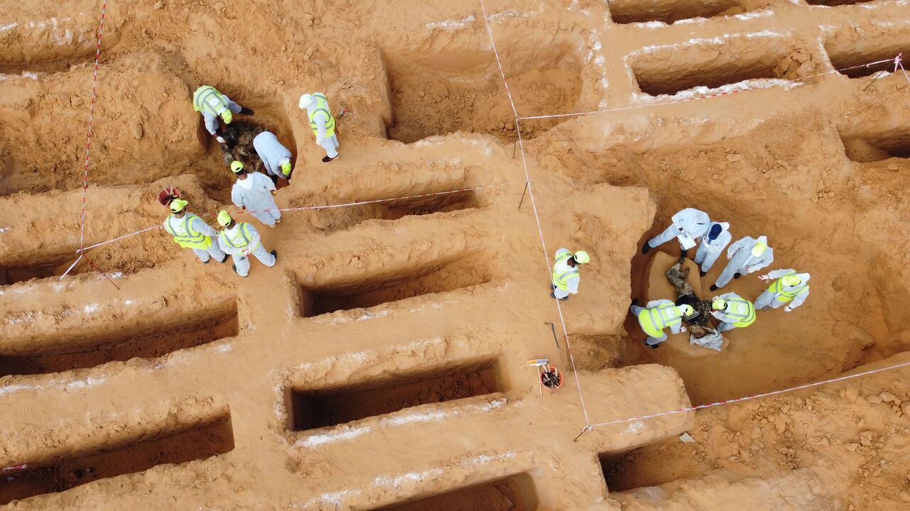 1229504866 This picture taken on November 7, 2020 shows an aerial view of members of the public body leading the "Search and Identification of the Missing," backed by the UN-recognised Government of National Accord (GNA), unearthing a mass grave site in western Libya's Tarhuna region. - Seventeen bodies have been unearthed in newly found mass graves in Tarhuna, taking the total exhumed in recent months to 112, the missing persons authority said on November 7. The graves are located in the region from where eastern str