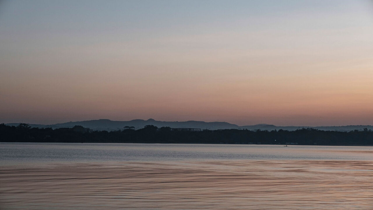 1229571597 A fisherman is pictured in his boat on lake Tana, in the city of Bahir Dar, Ethiopia, on November 11, 2020. - Lake Tana, a UNESCO biosphere reserve, is the origin of the blue Nile river that feeds the Grand Ethiopian Renaissance Dam (GERD). (Photo by EDUARDO SOTERAS / AFP) (Photo by EDUARDO SOTERAS/AFP via Getty Images)