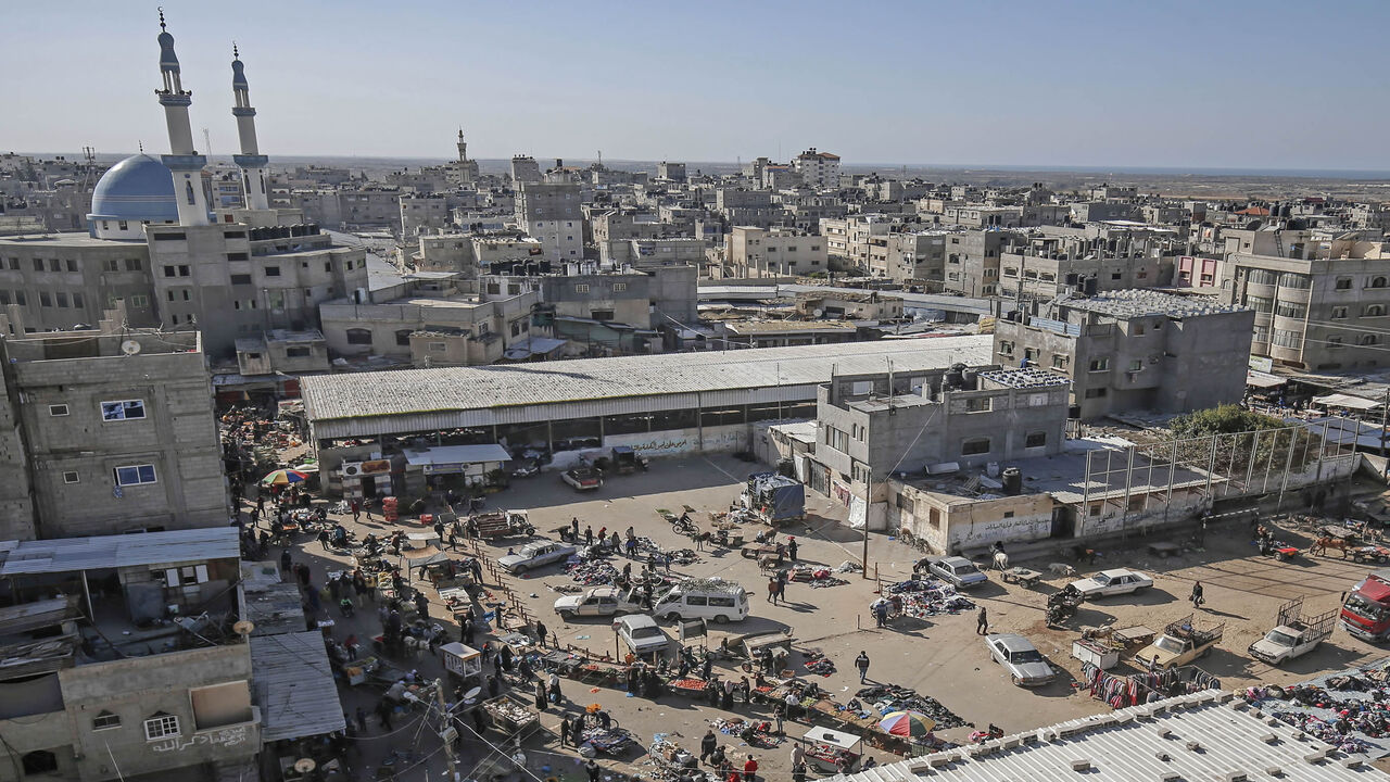 1230064403 A general view taken on December 10, 2020 shows a crowded main square in Rafah, one day before a comprehensive lockdown was imposed on weekends in the southern Gaza Strip, as cases of infections with the coronavirus surged in the Palestinian coastal enclave. (Photo by SAID KHATIB / AFP) (Photo by SAID KHATIB/AFP via Getty Images)