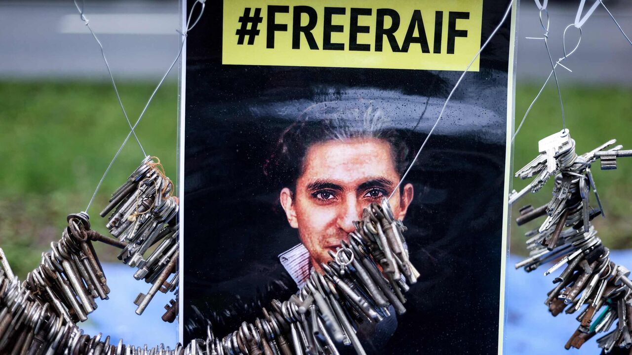 1230477600 A picture taken on January 8, 2021 shows a portrait of Raif Badawi during an action of the human rights NGO Amnesty International in front of the embassy of Saudi Arabia in Brussels, calling for the release of the jailed Saudi blogger. - Badawi was sentenced to 10 years in prison and 1,000 lashes for insulting Islam. (Photo by Kenzo TRIBOUILLARD / AFP) (Photo by KENZO TRIBOUILLARD/AFP via Getty Images)