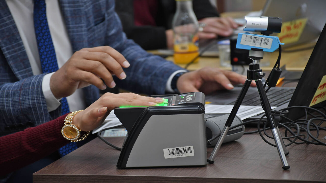 1230546189 An Iraqi woman updates her voter registration at the Independent High Electoral Commission Center in the southern Iraqi city of Nasiriyah in the Dhi Qar province on January 12, 2021. - Iraq's early parliamentary elections were promised by the PM for June but according to officials and politicians they are highly unexpected to be held without several month of delay. (Photo by Asaad NIAZI / AFP) (Photo by ASAAD NIAZI/AFP via Getty Images)