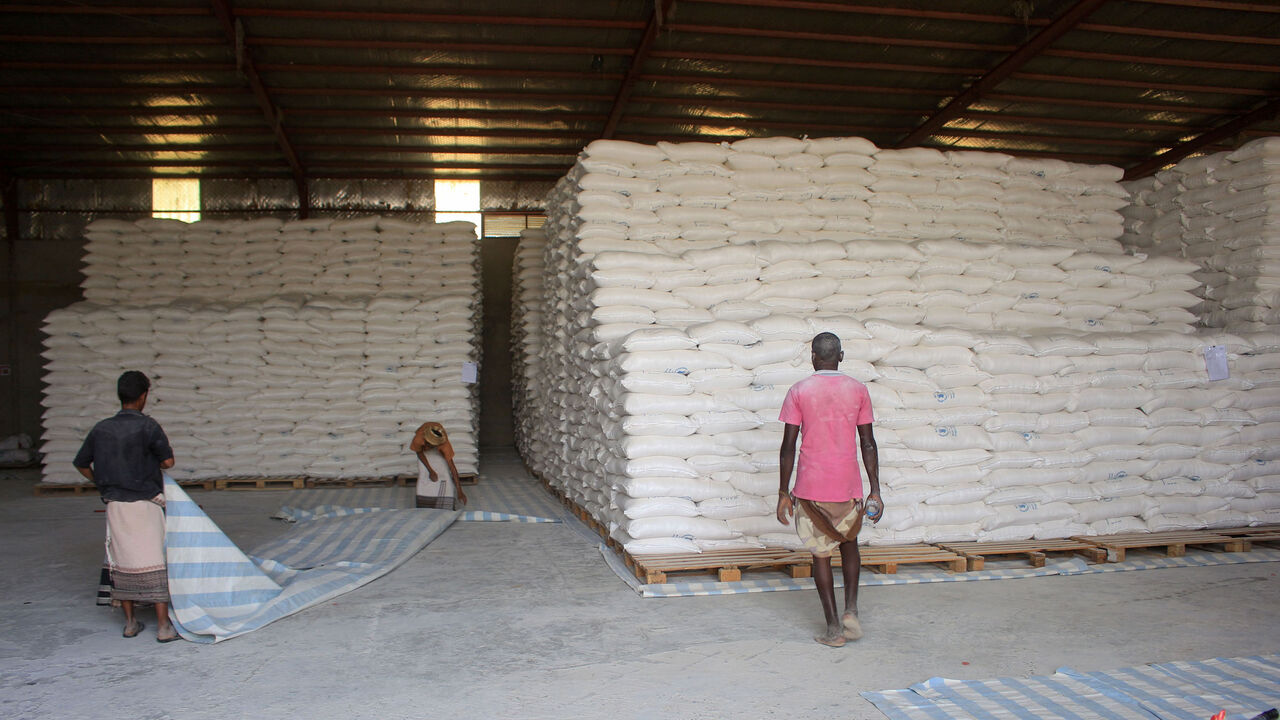 1230550831 Workers transport food aid provided by the World Food Programme (WFP) before distributing rations to displaced Yemenis in the northern province of Hajjah, on January 12, 2021. (Photo by ESSA AHMED / AFP) (Photo by ESSA AHMED/AFP via Getty Images)