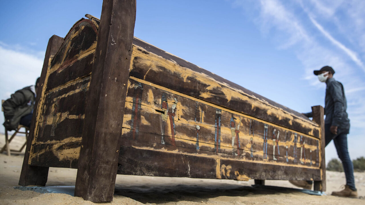1230634649 An adorned wooden sarcophagus is displayed during the official announcement of the discovery by an Egyptian archaeological mission of a new trove of treasures at Egypt's Saqqara necropolis south of Cairo, on January 17, 2021. - The discovery at the necropolis which lies 30kms south of the Egyptian capital, includes the funerary temple of Queen Naert, wife of King Teti, as well as burial shafts, coffins, and mummies dating back to the New Kingdom, dating back to nearly 3000 years. (Photo by Khaled DESOUKI /