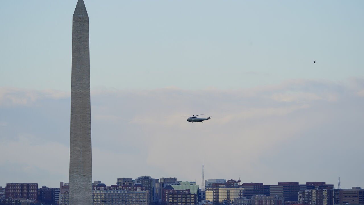 Marine One helicopter, with President Donald Trump and first lady Melania Trump aboard, flies over the National Mall in Washington, Wednesday, Jan. 20, 2021. (AP Photo/Patrick Semansky, Pool)