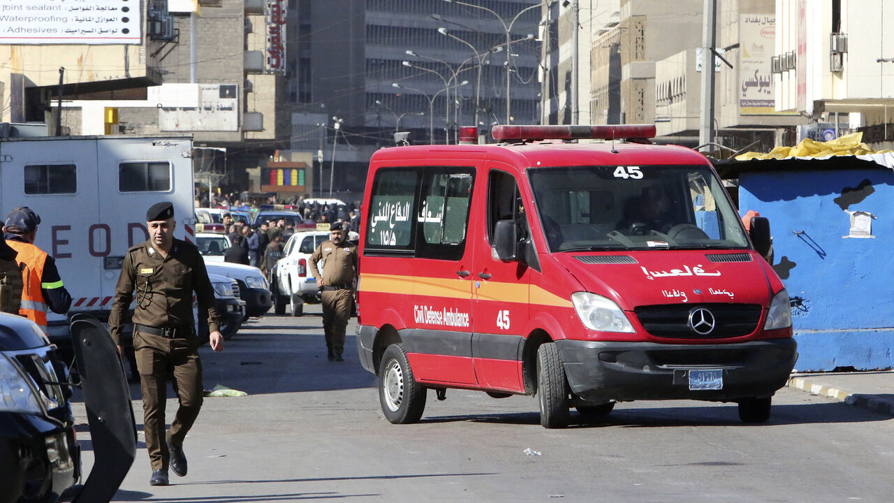 1230707509 A picture shows the scene of a twin suicide bombing on a bustling commercial street in the heart of Baghdad on January 21, 2021. - The toll in a twin suicide bombing in an open-air Baghdad market morning topped 20 dead and 40 wounded, an interior ministry official told AFP. The ministry said the first suicide bomber had rushed into the market and claimed to feel sick, so that people would gather around him. He then detonated his explosives. (Photo by Sabah ARAR / AFP) (Photo by SABAH ARAR/AFP via Getty Imag