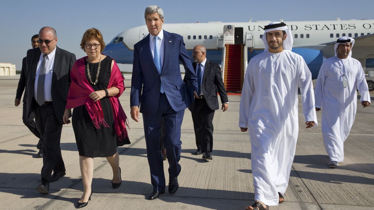 498390000 US Secretary of State John Kerry (C) walks with Deputy Chief of Mission Ethan Goldrich (far L), US Ambassador to the United Arab Emirates Barbara Leaf (2nd L) and Emirati Foreign Minister Sheikh Abdullah bin Zayed Al Nahyan (R) upon his arrival in Abu Dhabi, on November 23, 2015. Kerry arrived in Abu Dhabi on November 23 to meet his Emirati counterparts on efforts to build a Syrian opposition coalition to lead peace talks with the Damascus regime. AFP PHOTO / POOL / Jacquelyn Martin (Photo credit
