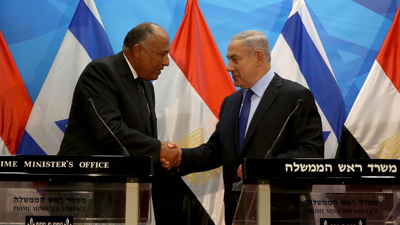 545830006 Israeli Prime Minister Benjamin Netanyahu (R) shakes hands with Egyptian Foreign Minister Sameh Shoukry after giving a joint statement prior to their meeting at his Jerusalem office on July 10, 2016.
Shoukry met Netanyahu in Jerusalem for talks on reviving peace efforts with the Palestinians, in the first such visit in nearly a decade and the latest sign of warming ties.
/ AFP / GALI TIBBON (Photo credit should read GALI TIBBON/AFP via Getty Images)