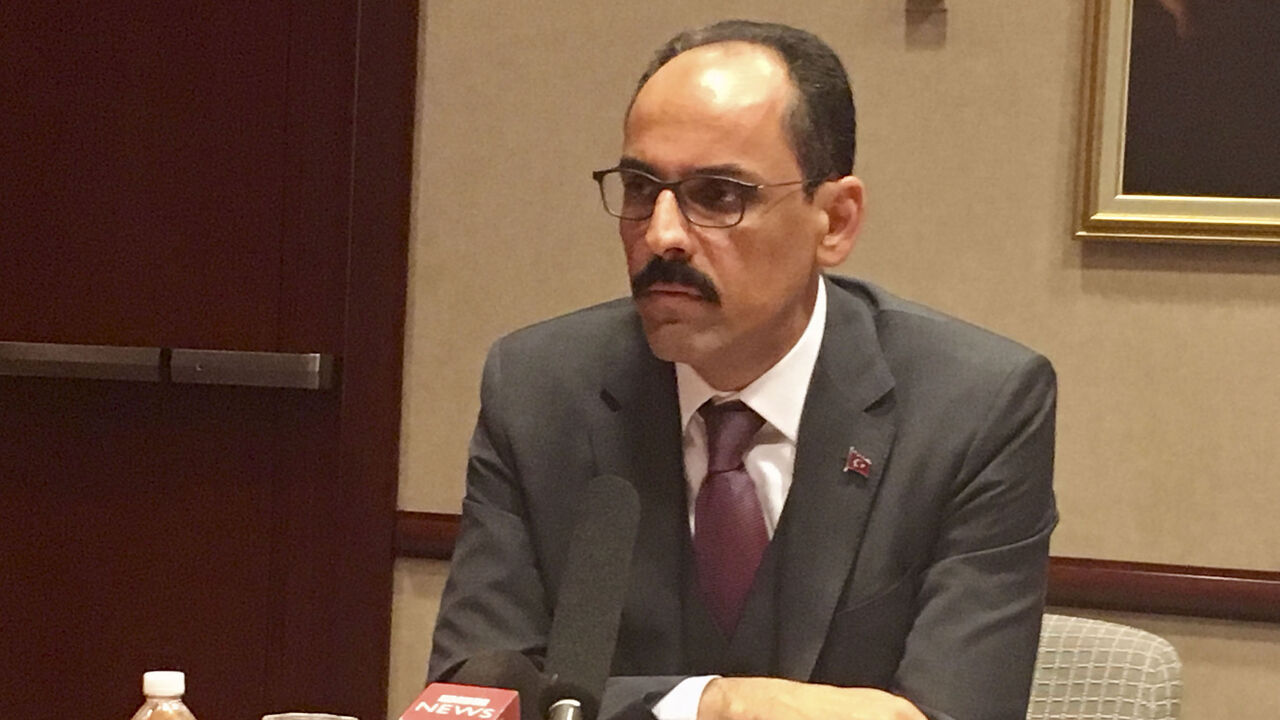 1137555490 Ibrahim Kalin, the spokesman for Turkish President Recep Tayyip Erdogan, speaks to reporters during a roundtable at the Turkish embassy in Washington, DC on April 16, 2019. - Kalin voiced hope that the United States would extend a waiver for Turkey on sanctions against buying oil from Iran. He also said that Turkey was explaining to the United States its purchase of a major arm system from Turkey, a decision that has rattled relations between the NATO allies. (Photo by Shaun TANDON / AFP) (Photo cred