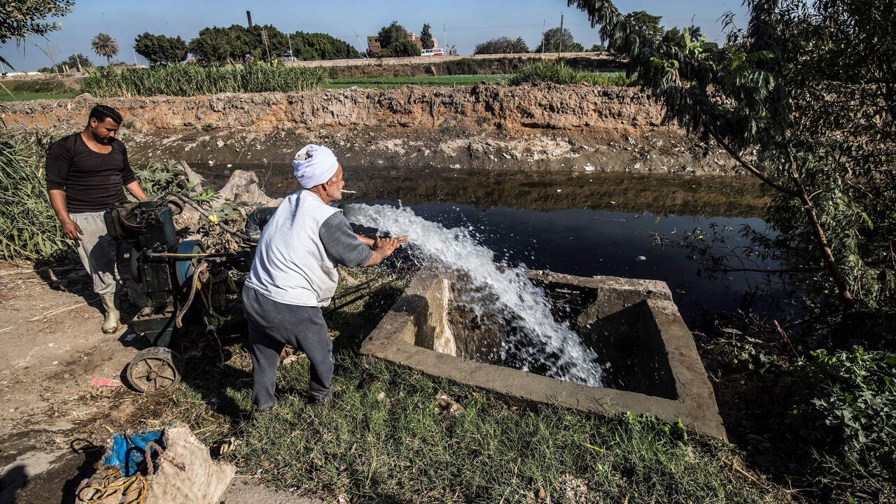 1186227188 Egyptian farmer Mohamed Omar (C), 65, supplies his farmland with water from a canal, fed by the Nile river, in the village of Baharmis on the outskirts of Egypt's Giza province, northwest of the capital Cairo, on December 1, 2019. - Egypt has for years been suffering from a severe water crisis that is largely blamed on population growth. Mounting anxiety has gripped the already-strained farmers as the completion of Ethiopia's gigantic dam on the Blue Nile, a key tributary of the Nile, draws nearer. Egypt vi