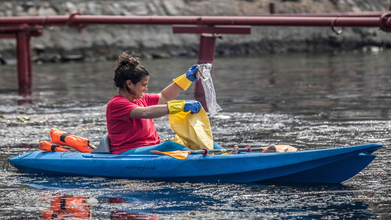 1207684697 Volunteers riding in kayaks take part in a water-waste removal and cleanup campaign in the Nile river off the island of Manial in Egypt's capital Cairo on March 7, 2020. - Early one morning in Cairo, a flotilla of some 300 environmental determined activists paddle their kayaks across the Nile, fishing out garbage from the mighty waterway that gave birth to Egyptian civilisation but now faces multiple threats. In the past three years they say they have picked some 37 tonnes of cans, plastic bottles, disposab