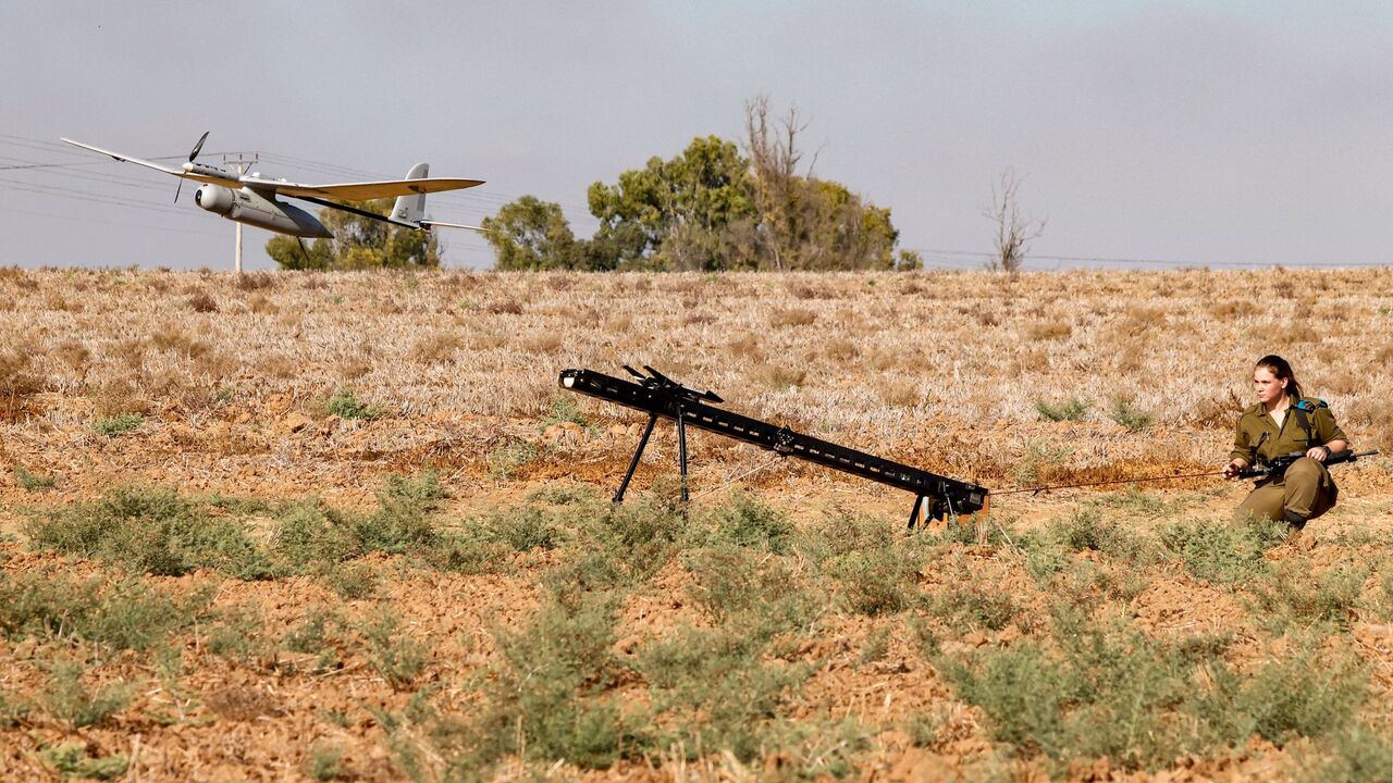 1228140036 An Israeli soldier watches an Elbit Systems Skylark I unmanned aerial vehicle (UAV or drone) taking off near the border with the Gaza Strip in southern Israel on August 21, 2020, as part of monitoring operations in the area. (Photo by JACK GUEZ / AFP) (Photo by JACK GUEZ/AFP via Getty Images)