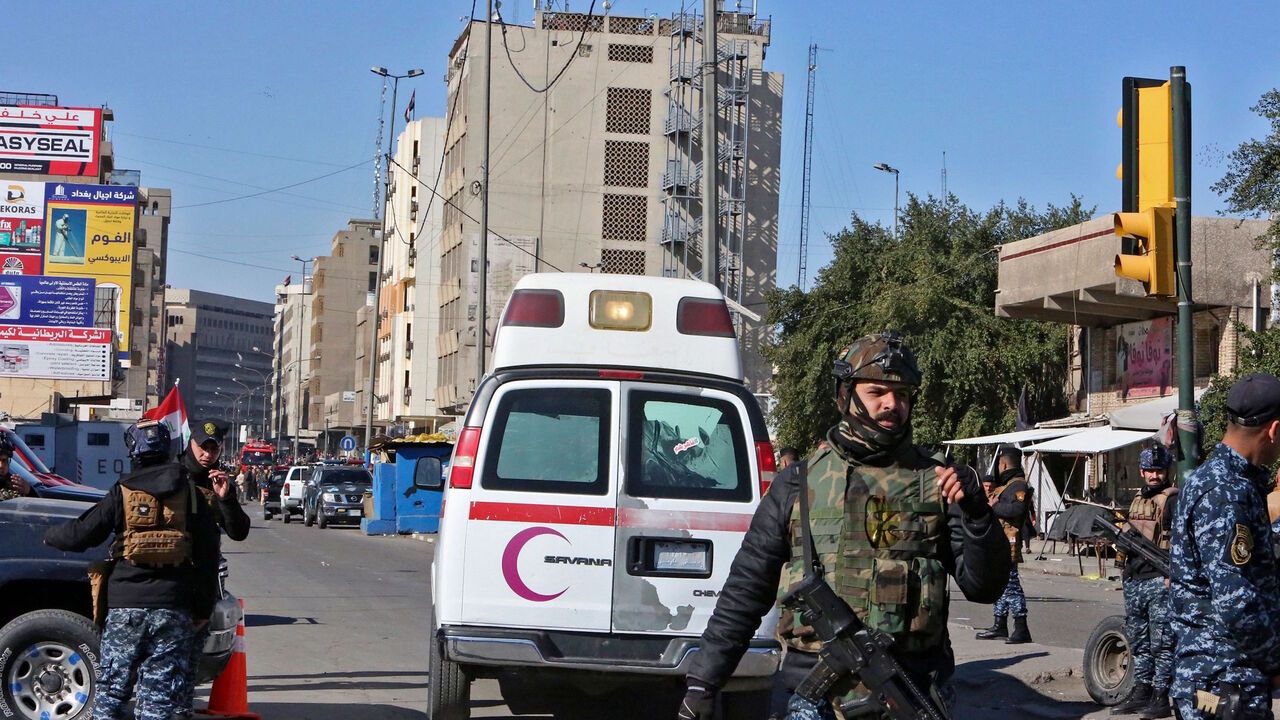 1230707369 A picture shows the scene of a twin suicide bombing on a bustling commercial street in the heart of Baghdad on January 21, 2021. - The toll in a twin suicide bombing in an open-air Baghdad market morning topped 20 dead and 40 wounded, an interior ministry official told AFP. The ministry said the first suicide bomber had rushed into the market and claimed to feel sick, so that people would gather around him. He then detonated his explosives. (Photo by Sabah ARAR / AFP) (Photo by SABAH ARAR/AFP via Getty Imag