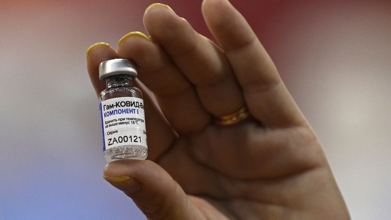 1230927991 A health worker displays a vial of the Sputnik V vaccine against COVID-19, in a vaccination centre for medical health workers, at the basketball court of Argentine club River Plate, bellow the grandstand of the Monumental stadium, in Buenos Aires on February 2, 2020. (Photo by Juan MABROMATA / AFP) (Photo by JUAN MABROMATA/AFP via Getty Images)