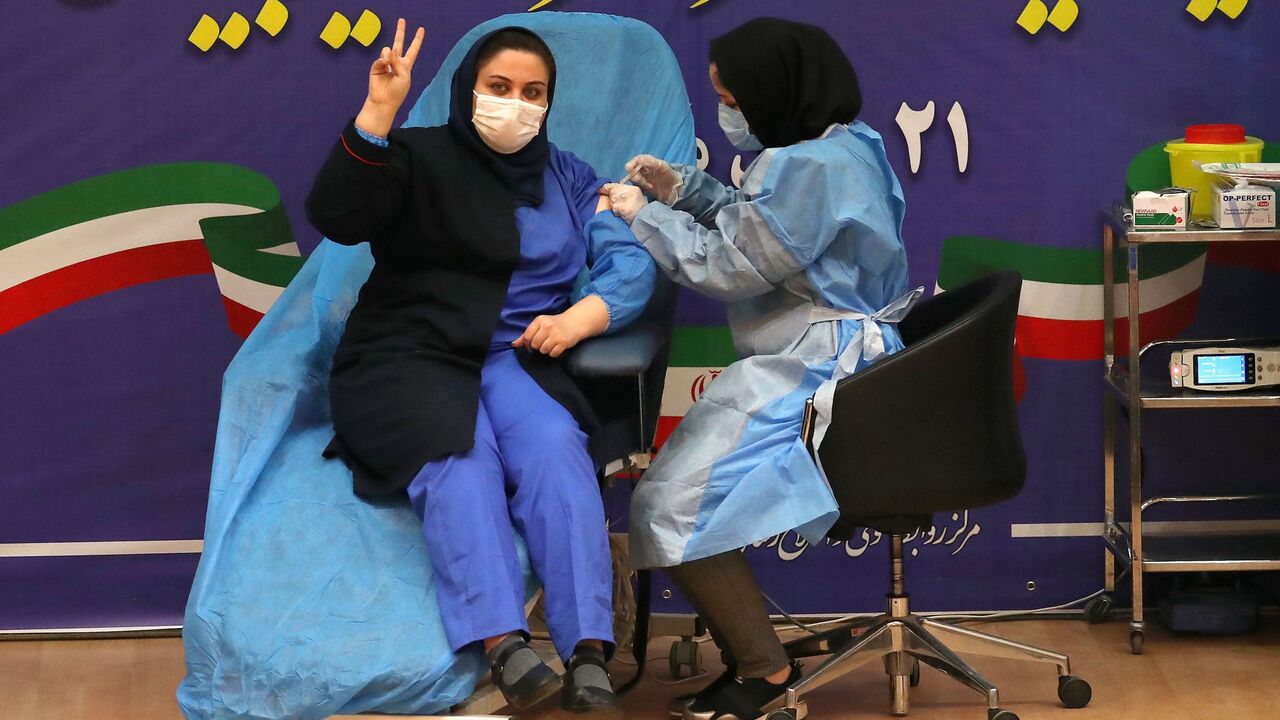 1231057792 TOPSHOT - Iranian health worker Sara Gudarzi receives the COVID-19 vaccine as the country launches its inoculation campain, at the Imam Khomeini hospital in the capital Tehran, on February, 9, 2021. - The inoculation effort for 80-million-plus population is starting with Russia's Sputnik V vaccine, authorities have said, as the novel coronavirus has infected 1.4 million people in Iran and killed more than 58,500, according to the health ministry. (Photo by ATTA KENARE / AFP) (Photo by ATTA KENARE/AFP via Ge