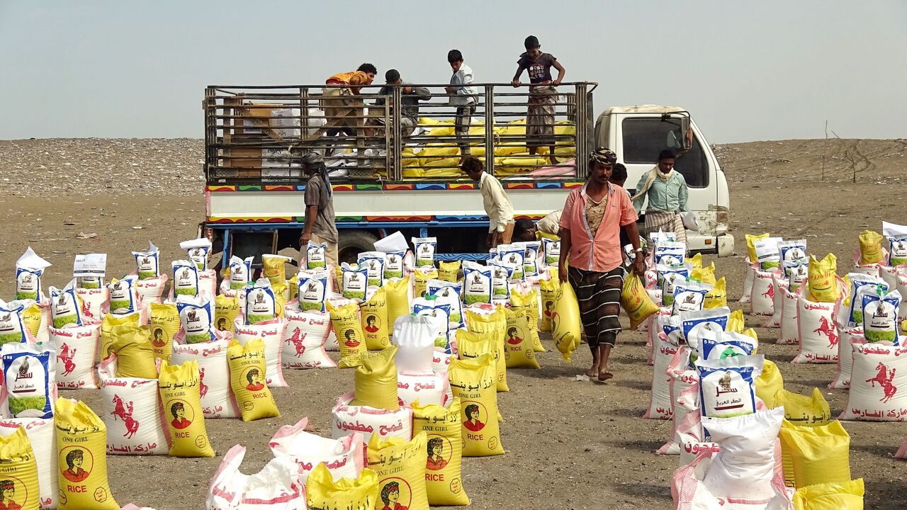 1231065216 Displaced Yemenis receive food aid donated by a British organisation in Yemen's western province of Hodeida on February 9, 2021. - Since 2014, Yemen has been engulfed in a war between the internationally recognised government -- supported by a Saudi-led military coalition -- and the Iran-backed Huthi rebels that has triggered a devastating humanitarian crisis. (Photo by Khaled Ziad / AFP) (Photo by KHALED ZIAD/AFP via Getty Images)