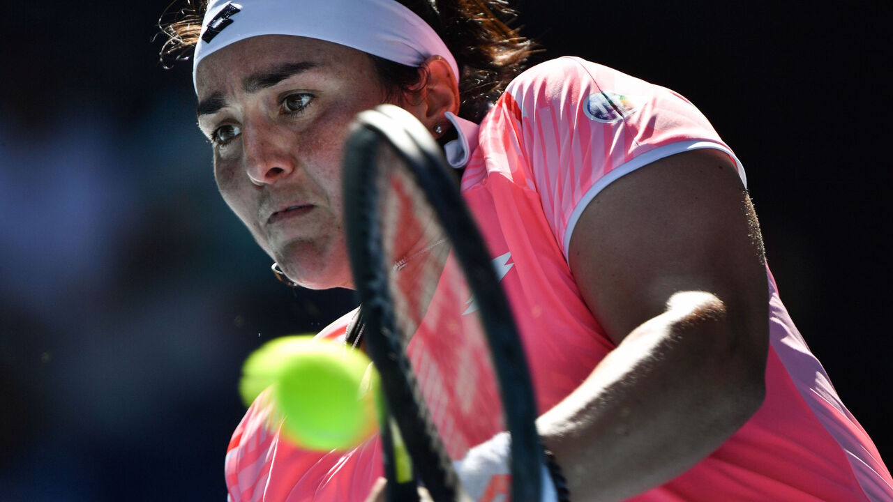 1231112990 Tunisia's Ons Jabeur hits a return against Japan's Naomi Osaka during their women's singles match on day five of the Australian Open tennis tournament in Melbourne on February 12, 2021. (Photo by Paul CROCK / AFP) / -- IMAGE RESTRICTED TO EDITORIAL USE - STRICTLY NO COMMERCIAL USE -- (Photo by PAUL CROCK/AFP via Getty Images)
