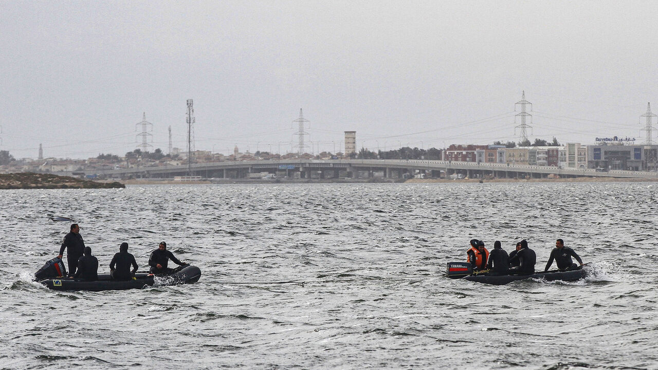 1231340882 Rescue divers conduct search operations for victims of a capsized boat in Lake Mariout, 20 kilometres (12 miles) west of Egypt's second city of Alexandria on February 23, 2021. - Nine people drowned and at least four were missing after the boat chartered for a family fishing trip capsized. State newspaper Al-Ahram said a six-month-old infant was among the family members drowned. Six survivors are receiving treatment in local hospitals while emergency teams have been sent to the lake to search for the missin