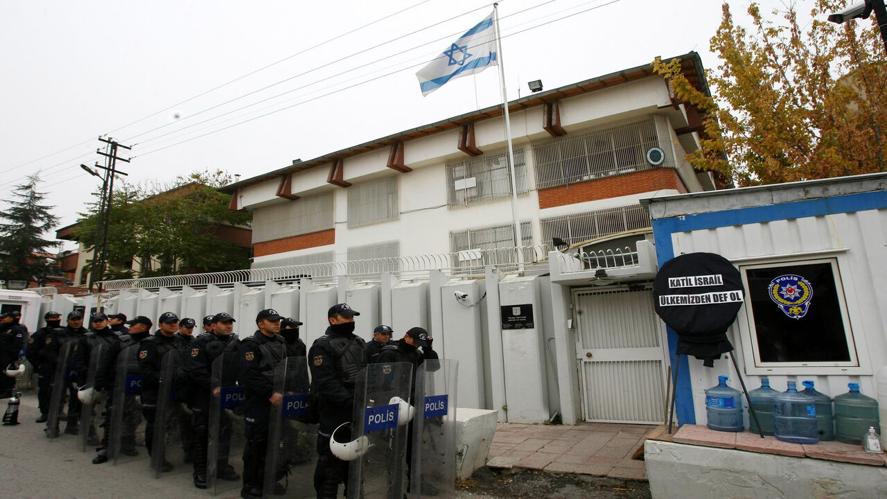 156789229 Riot police stand in formation as unseen Turkish protesters demonstrate against Israel's attack on Gaza outside the Israeli embassy in Ankara on November 21, 2012. Turkish Prime Minister Recep Tayyip Erdogan on Tuesday accused Israel of "ethnic cleansing" in Gaza, saying the Jewish state's air raids could not be considered self-defence. AFP Photo/ADEM ALTAN (Photo credit should read ADEM ALTAN/AFP via Getty Images)