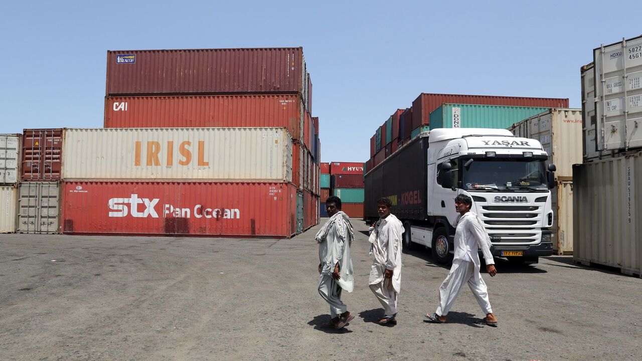 475095004 TO GO WITH AFP STORY OF CYRIL JULIEN
Iranian workers walk near containers at the Kalantari port in city of Chabahar on May 12, 2015. Chabahar, located on the coast of Sistan-Baluchistan (south-east), is open to the Oman Sea and the Indian Ocean. It is Iran's gateway to Pakistan and Afghanistan in the east, the Central Asian countries to the north, and Turkey and the Gulf countries in the west. AFP PHOTO / ATTA KENARE (Photo credit should read ATTA KENARE/AFP via Getty Images)