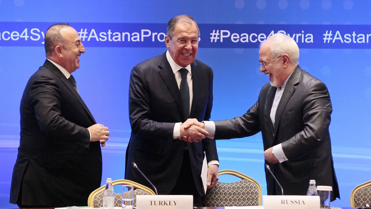 932700516 Russian Foreign Minister Sergei Lavrov (C) shakes hands with Iranian Foreign Minister Mohammad Javad Zarif (R) and Turkish Foreign Minister Mevlut Cavusoglu following their talks on Syria in Astana on March 16, 2018. / AFP PHOTO / Alexey FILIPPOV (Photo credit should read ALEXEY FILIPPOV/AFP via Getty Images)