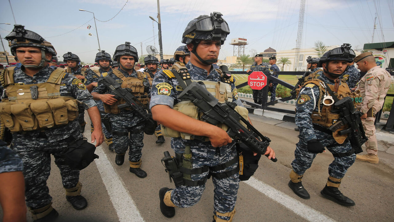 1177723227 Iraqi security forces guard a symbolic funeral procession attended by high-ranking officials in Baghdad on October 23, 2019 for Major General Ali al-Lami, a commander of the Iraqi Federal Police's Fourth Division, who was killed the previous day in Samarra in the province of Salahuddin, north of the Iraqi capital. - The police commander was killed in an ambush on October 22 which Iraqi security forces blamed on dormant cells of the Islamic State (IS) group. (Photo by AHMAD AL-RUBAYE / AFP) (Photo by AHMAD A