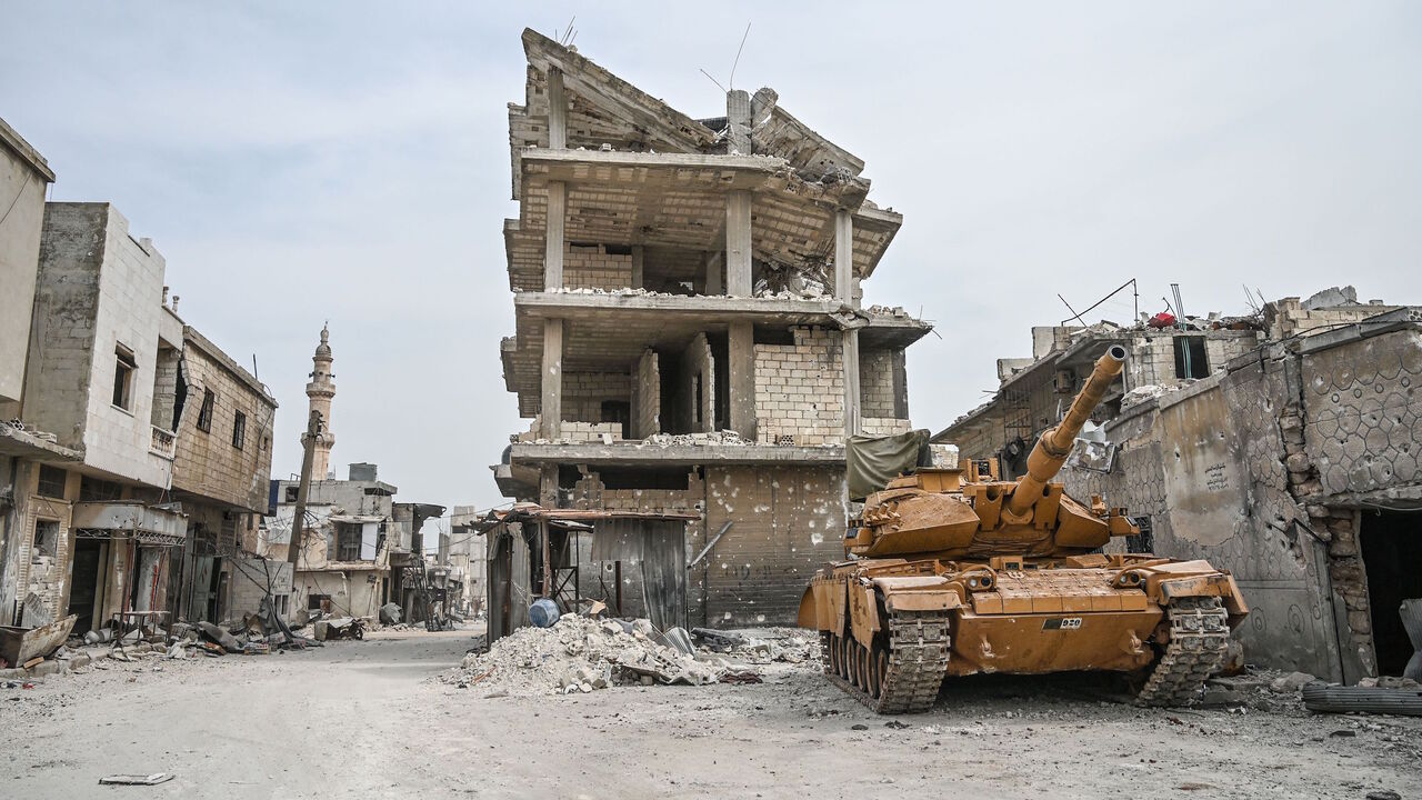 1206599156 A Turkish military tank is seen in a destroyed neighbourhood of Sarmin town, about eight kilometres southeast of the city of Idlib in northwestern Syria, on March 10, 2020. - When protesters in March 2011 demanded their rights and regime change, they likely never imagined it would trigger a reaction that has led to the 21st century's biggest war. Nine years on, President Bashar al-Assad is still in power and there to stay, more than 380,000 people have died, dozens of towns and cities razed to the ground an
