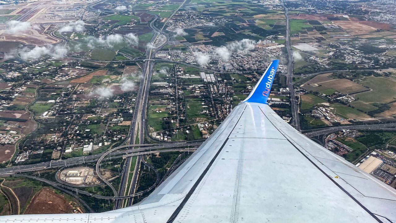 1230175310 This picture taken on December 16, 2020 shows a view above Israel from the window of a plane aboard a flydubai flight from Ben Gurion International Airport to Dubai upon departure. - The first flydubai aircraft landed in Dubai from Tel Aviv on November 26, inaugurating commercial flights between the two cities following the normalisation of ties between the UAE and Israel. The United Arab Emirates in September signed a landmark US-brokered deal to formalise relations with Israel, the first such agreement by