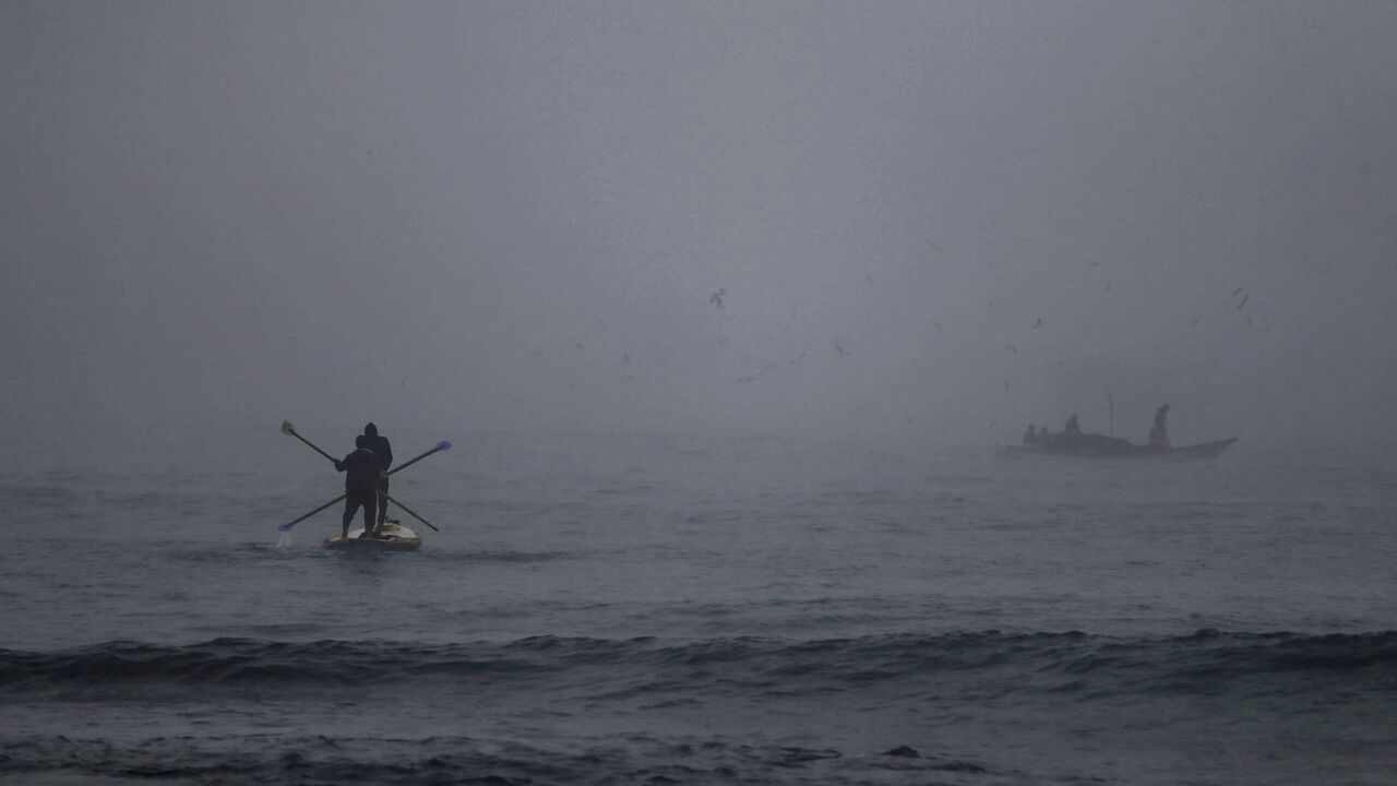 1230402371 Palestinian fishermen set out to sea amid heavy morning fog in Gaza City, on January 3, 2021. (Photo by Mohammed ABED / AFP) (Photo by MOHAMMED ABED/AFP via Getty Images)