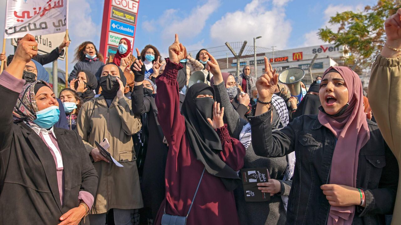 1230983232 Israeli Arab women take part in a protest after a student was killed in a reported police shootout this week, in the northern Arab-Israeli town of Umm-Al Fahem on February 5, 2021. - Hundreds of Arab Israelis demonstrated protesters defied coronavirus restrictions on gatherings to demonstrate in front of the police station in the Arab-Israeli city of Umm al-Fahm. (Photo by AHMAD GHARABLI / AFP) (Photo by AHMAD GHARABLI/AFP via Getty Images)