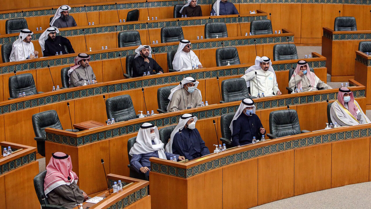 1231196957 Kuwaiti members of parliament attend a special session following-up on measures undertaken by the government of limit the spread of COVID-19 coronavirus disease, at the National Assembly headquarters in Kuwait City on February 16, 2021. (Photo by YASSER AL-ZAYYAT / AFP) (Photo by YASSER AL-ZAYYAT/AFP via Getty Images)