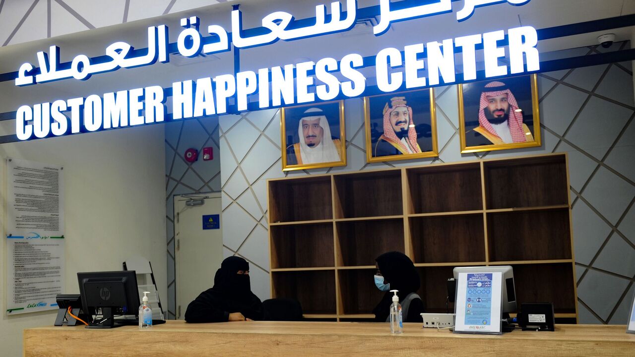 1231311049 Saudi female employees work at the customers service desk at a hypermarket, newly launched by the operator LuLu and run by a team of women, in the Saudi Arabian port city of Jeddah, on February 21, 2021. (Photo by Amer HILABI / AFP) (Photo by AMER HILABI/AFP via Getty Images)