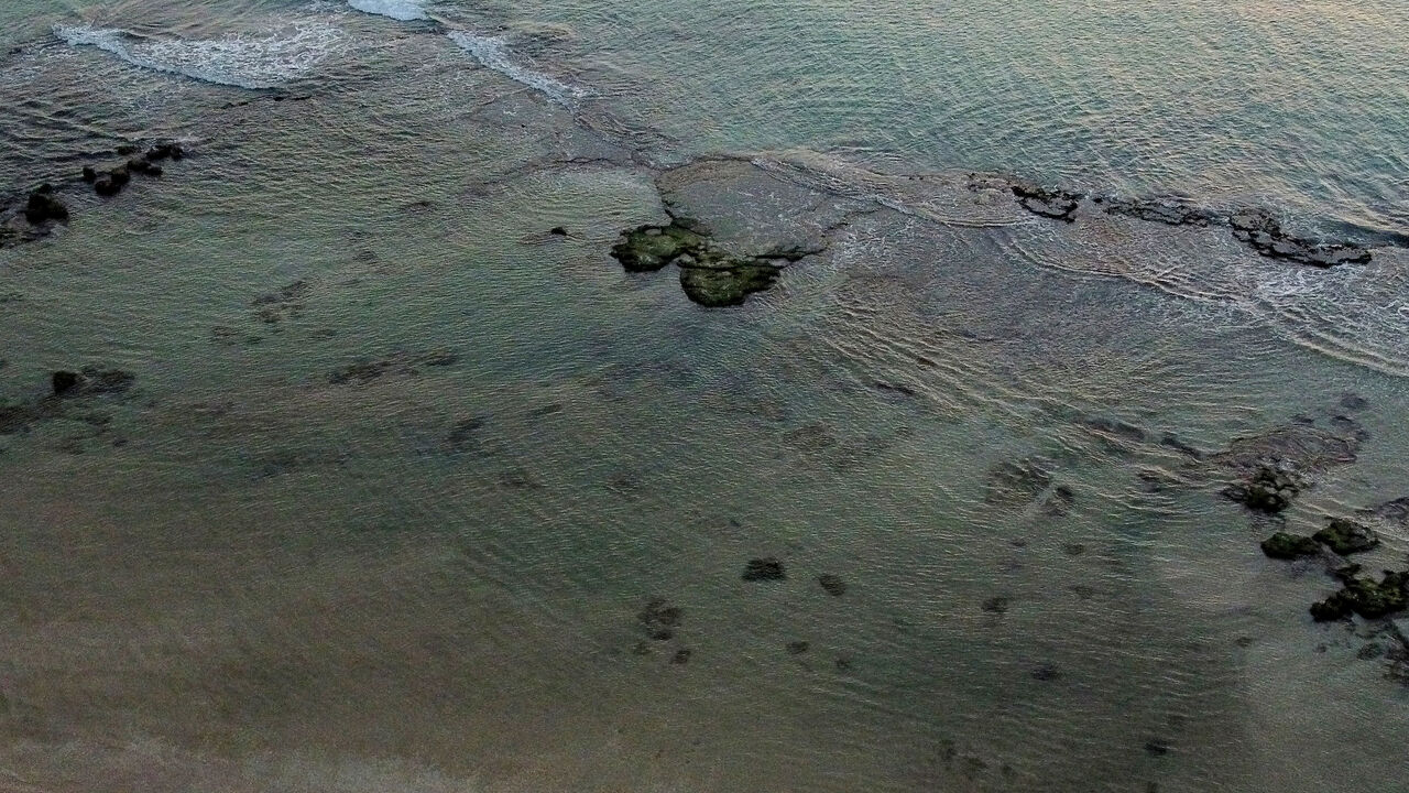 1231327515 HADERA, ISRAEL - FEBRUARY 22: An aerial view over Israel's coast line after an oil spill on February 22, 2021 in Hadera, Israel. Tar started washing up on the country's beaches last week, leading its interior minister to advise people to stay away from beaches. Authorities suspect the spill was caused by a leak from an offshore ship. (Photo by Amir Levy/Getty Images)
