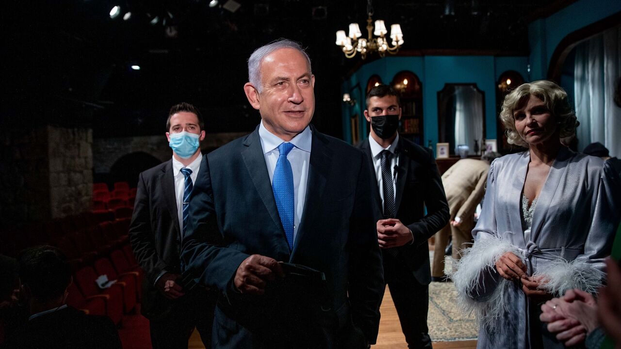 1231343027 Israeli Prime Minister Benjamin Netanyahu (L) meets Israeli actress Carmit Mesilati Kaplan (R) during a visit to the Khan theatre ahead of the re-opening of the culture sector following Covid-19 imposed closures, on February 23, 2021 in Jerusalem. - Israel took a step towards normalcy on February 21, re-opening a raft of businesses and services from pandemic lockdowns, but with some only available to fully vaccinated "green pass" holders. (Photo by Ohad ZWIGENBERG / POOL / AFP) (Photo by OHAD ZWIGENBERG/POO