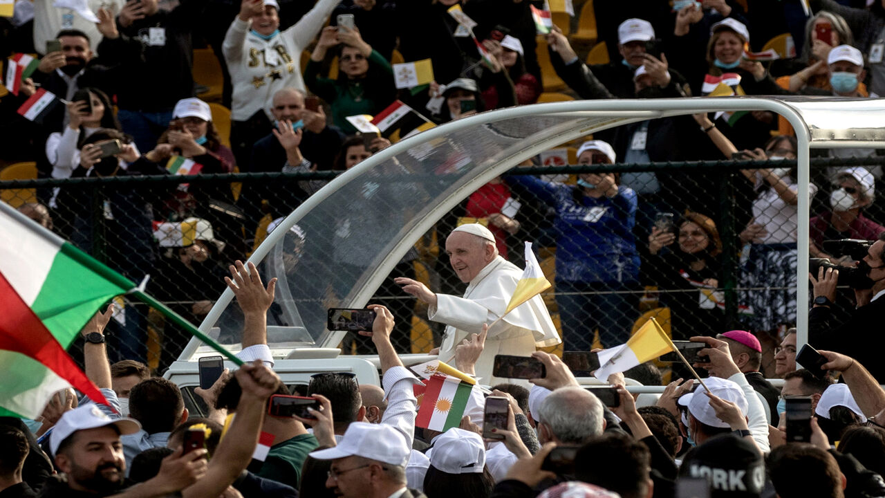 1305808371 ERBIL, IRAQ - MARCH 07: (EDITORS NOTE: Transmitted with alternate crop) Pope Francis waves to the crowd as he arrives to conduct mass at the Franso Hariri Stadium on March 07, 2021 in Erbil, Iraq. Pope Francis arrived in Erbil, the final stop of his historic four-day visit, the first-ever papal visit to Iraq. In his first foreign trip since the start of the pandemic, Pope Francis visited Baghdad, Najaf, Erbil, and the cities of Qaraqosh and Mosul, which were heavily destroyed by ISIS. Although the trip is