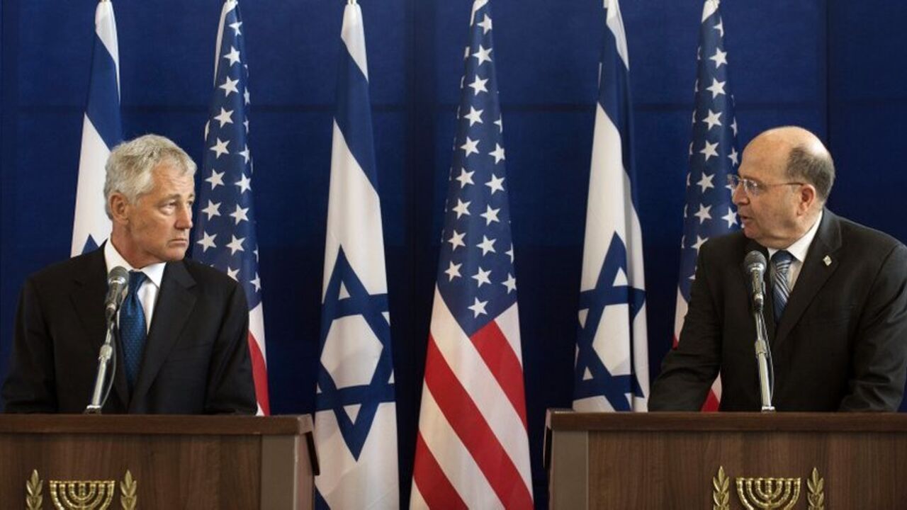 U.S. Defense Secretary Hagel listens as his Israeli counterpart Yaalon speaks during a joint news conference in Tel Aviv U.S. Defense Secretary Chuck Hagel (L) listens as his Israeli counterpart Moshe Yaalon speaks during a joint news conference at Kirya base in Tel Aviv April 22, 2013. Israel suggested on Monday it would be patient before taking any military action against Iran's nuclear programme, saying during a visit by Hagel there was still time for other options. REUTERS/Jim Watson/Pool (ISRAEL - Tags: POLITICS) - RTXYVS7