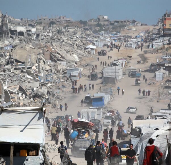 Palestinians carry their belongings as they flee Gaza City, May 16, 2025. 