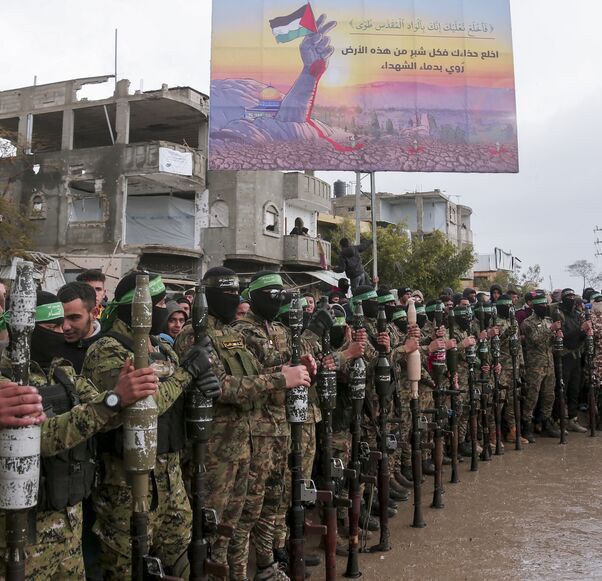 Hamas fighters gather at the site of the handing over of two Israeli hostages in Rafah in the southern Gaza Strip on Feb. 22, 2025. 