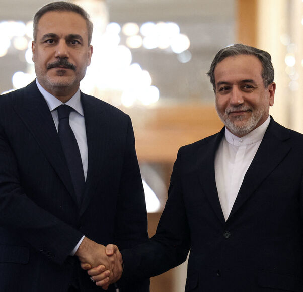 Iran's Foreign Minister Abbas Araghchi (R) shakes hands with Turkey's Foreign Minister Hakan Fidan during press conference in Tehran on Nov. 30, 2025. 