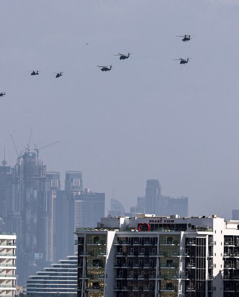 United Arab Emirates army helicopters fly from the Burj al Arab hotel (R) toward Burj Khalifa, Dubai, Jan. 16, 2026.