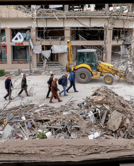 People inspect destruction at a business building that housed the offices of the Doha-headquartered news network Al Araby TV following a missile strike earlier in the day, Tehran, Iran, March 29, 2026.