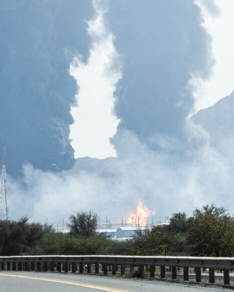 Smoke and flames rise from an energy installation in the Gulf emirate of Fujairah on March 14, 2026. Smoke could be seen rising from the direction of a major UAE energy installation on March 14, in what appeared to be the latest strike targeting the Gulf's petroleum facilities hours after the US struck Iran's Kharg Island. (Photo by AFP via Getty Images) /