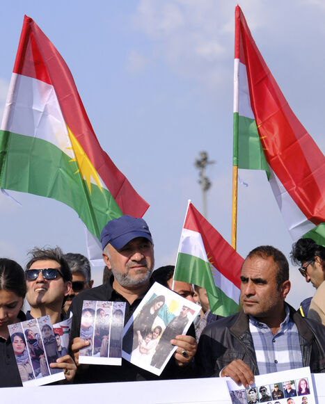 People wave flags of Kurdistan during a march in Erbil, Iraq, on April 21, 2026, expressing support for the unity of Iranian Kurdish parties and condemning Iranian missile strikes and military actions against Kurdish groups in the Kurdistan Region of Iraq. 