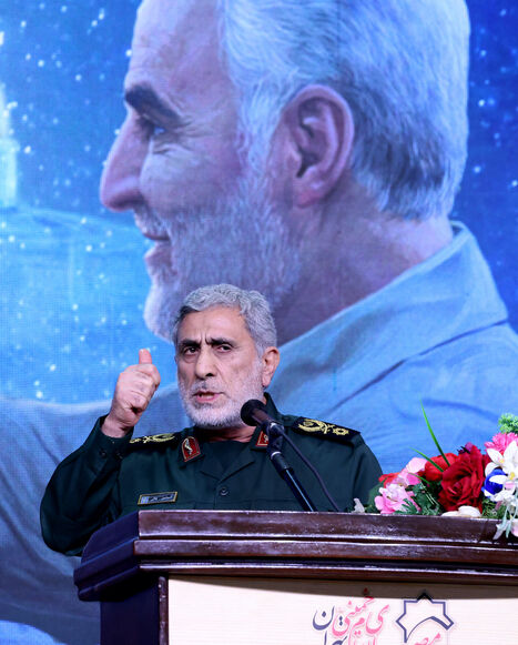 The commander of the Quds Force of the Islamic Revolutionary Guard Corps, Esmail Qaani, speaks during a commemoration ceremony marking the anniversary of the 2020 killing of Guards general Qasem Soleimani (on screen) in the capital Tehran on Jan. 3, 2024. 
