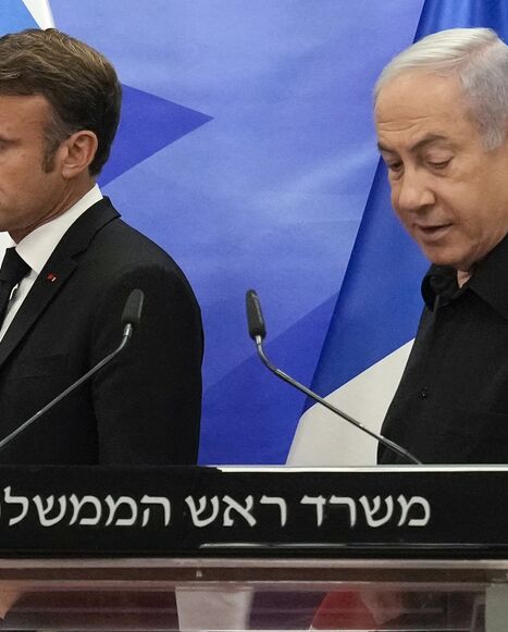 Israeli Prime Minister Benjamin Netanyahu and French President Emmanuel Macron arrive to hold a joint press conference in Jerusalem, Oct. 24, 2023.