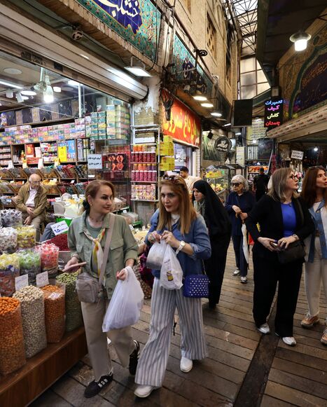 shoppers walking through the Tajrish Bazaar, a traditional market in Tehran