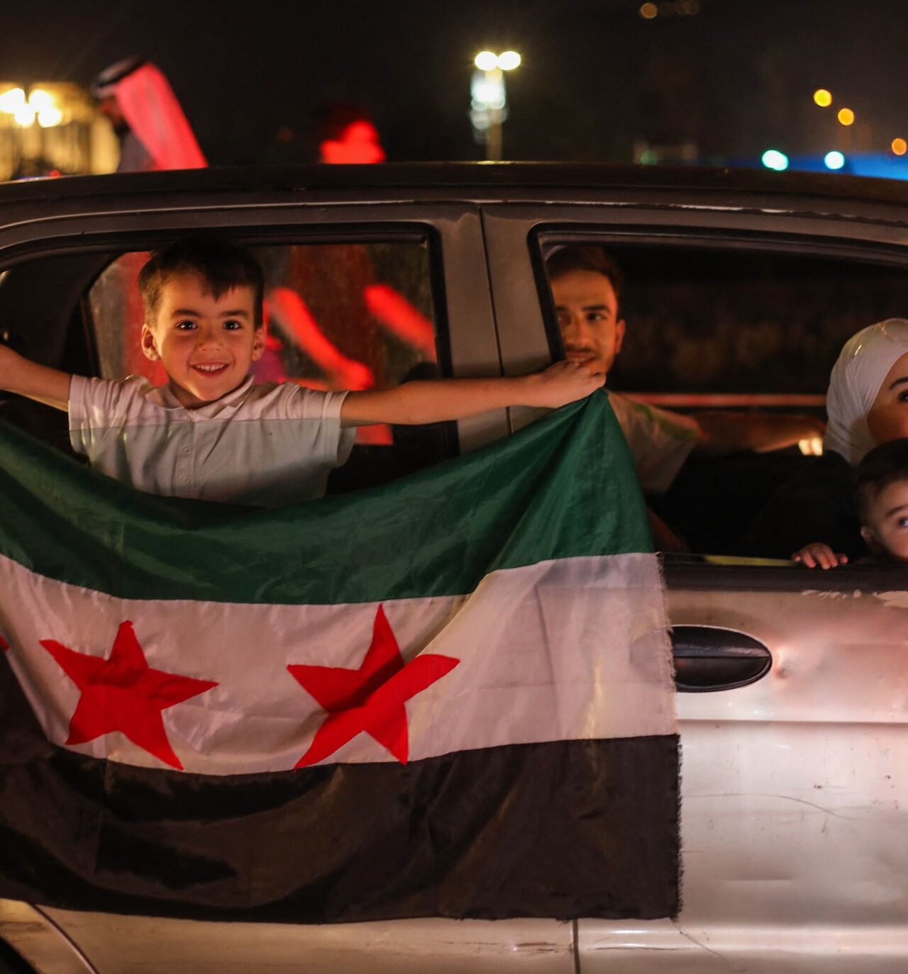 People celebrate in Damascus' Omeyyad Square after US President Donald Trump's decision to lift sanctions in Syria, on May 13, 2025.