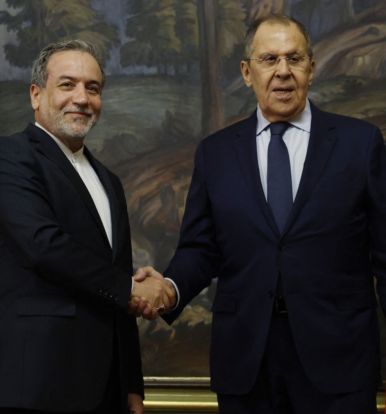 Russia's foreign minister, Sergei Lavrov (R), shakes hands with Iran's foreign minister, Abbas Araghchi (L), during a joint press conference following their talks in Moscow on April 18, 2025.