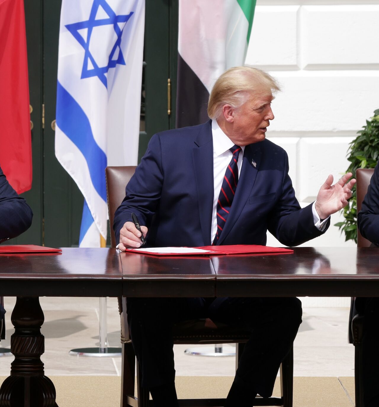 Prime Minister of Israel Benjamin Netanyahu, US President Donald Trump, and Foreign Affairs Minister of the United Arab Emirates Abdullah bin Zayed bin Sultan Al Nahyan.