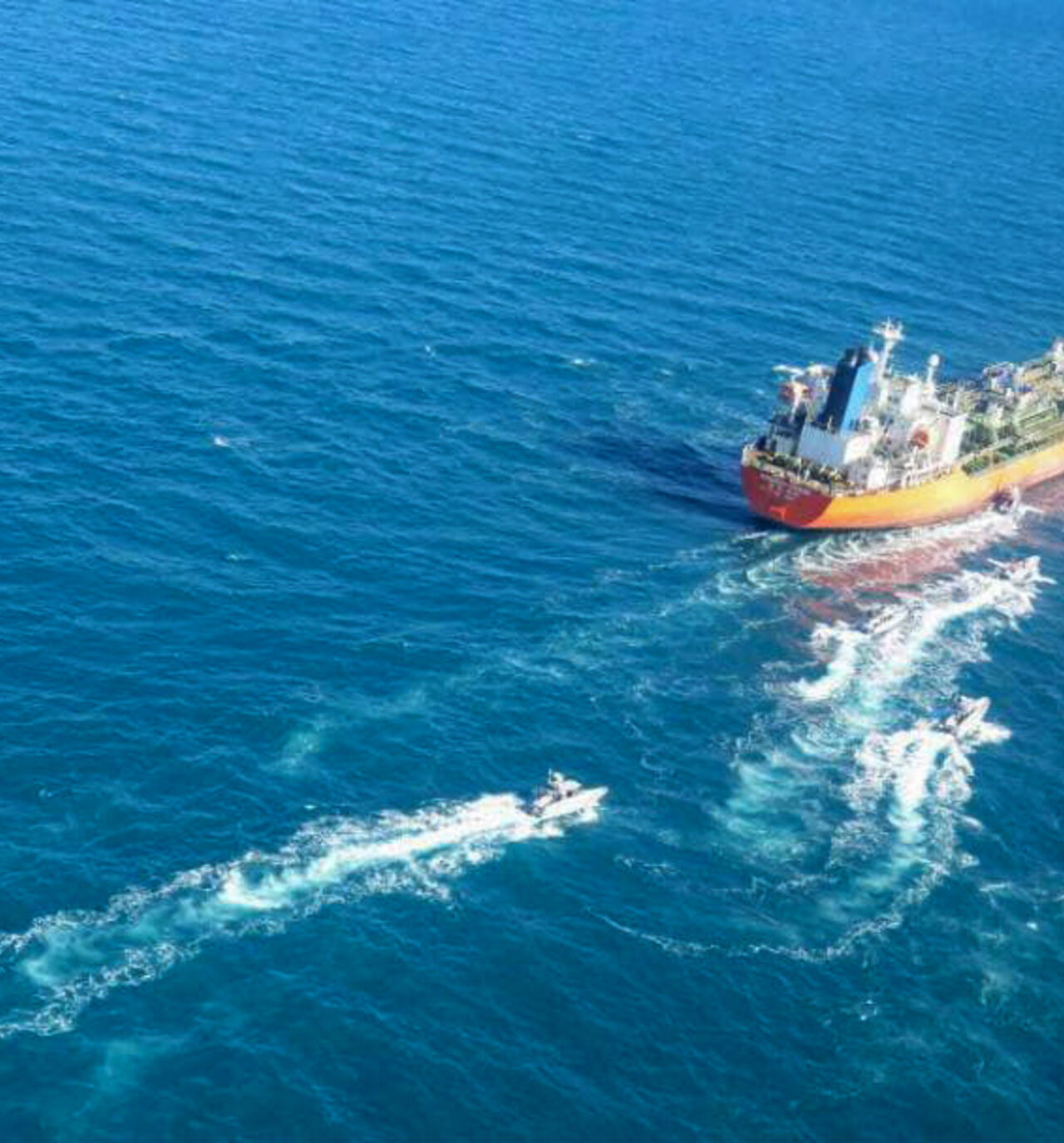 A picture obtained by AFP from the Iranian news agency Tasnim on Jan. 4, 2021, shows the South Korean-flagged tanker being escorted by Iran's Revolutionary Guards navy after being seized in the Gulf.